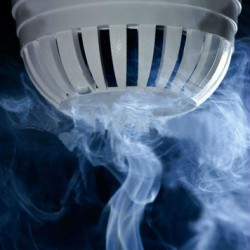 stock-photo-macro-view-of-wispy-smoke-around-white-fire-sensor-or-smoke-detector-dark-background-53917399